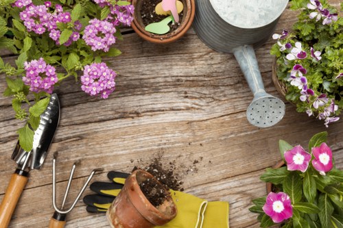 Front view of a gardener with tools in a Wimbledon garden