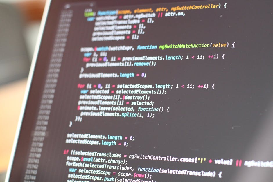 A close-up photograph of a computer screen displaying lines of colorful programming code with syntax highlighting. The code appears to be written in JavaScript or a similar language, featuring functio