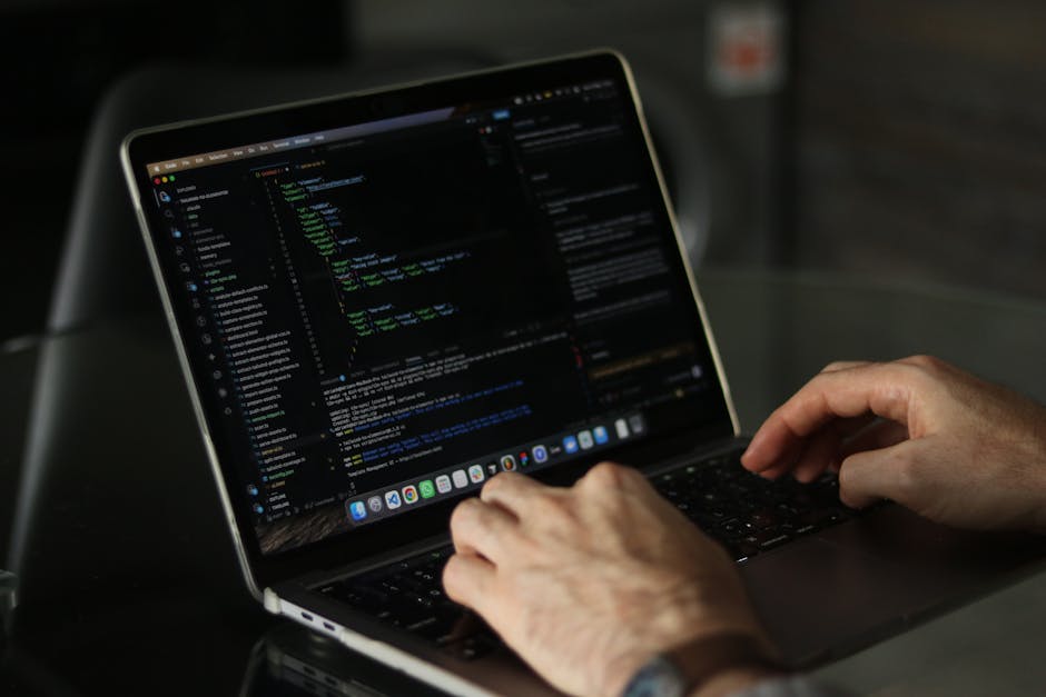 Close-up image of a computer screen displaying a webpage's HTML code, showing lines of colored tags and text in a code editor. The background is blurred, emphasizing the detailed syntax highlighting i